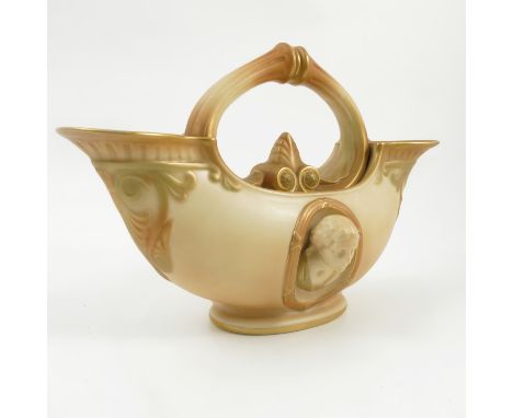 A Royal Worcester blush ivory double ended conch shell centre piece, moulded with busts and central handle, shape number 470,