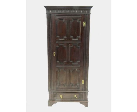 An antique oak cupboard, with a moulded panel door fitted with a drawer, width 33ins
