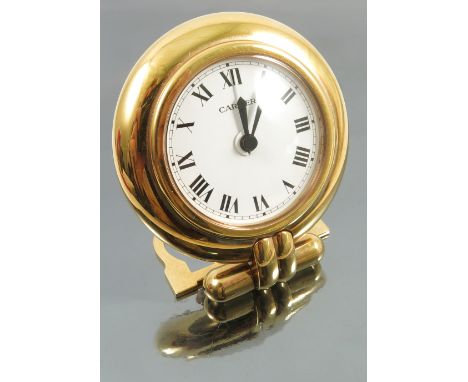 A Cartier bed side quartz alarm clock, the circular white dial with black Roman numerals and hands, white alarm hand, the cir