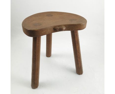 A three legged stool, with shaped seat Robert Thompson of Kilburn - Mouseman