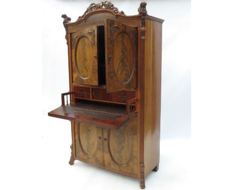 A 19th century mahogany Secretaire a Abattant, having two oval panel doors over a secret drawer, having two further oval pane