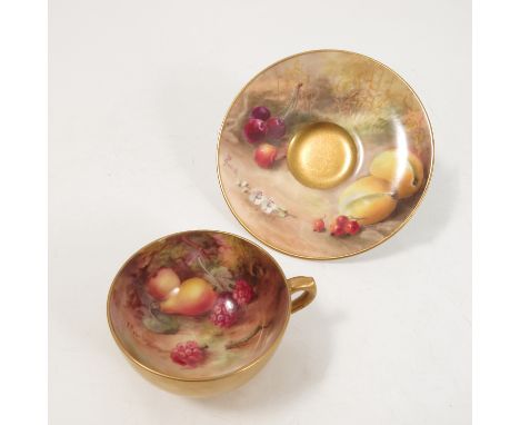 A Royal Worcester cabinet cup and saucer, the interior of the cup and saucer hand painted with fruit to a mossy ground by Rob