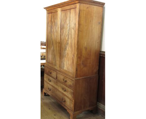 A 19th century mahogany linen press, having two panel doors opening to reveal an altered interior, with two short drawers ove