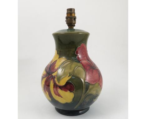A Moorcroft pottery lamp base, decorated in the Hibiscus pattern, with shade decorated with a print of huntsmen on horseback,