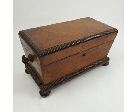 A late Georgian tea caddy, possibly in burr satinwood, with two lidded compartments and a mixing bowl, on four turned feet, w