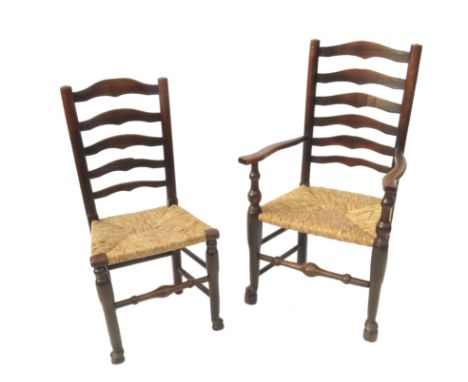 A set of eight (6 + 2) North Country style ladder back dining chairs, with rushed seats, turned legs, united by turned stretc