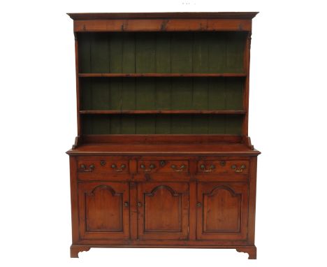 A 18th century style cupboard dresser, with close fitted delft rack over, fitted with three drawers to base, having three arc