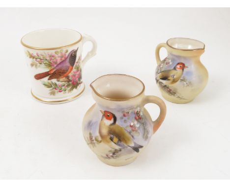 A pair of Locke and Co Worcester blush ivory jugs, hand painted with birds and flowers by H Wall, height 2.25ins, together wi