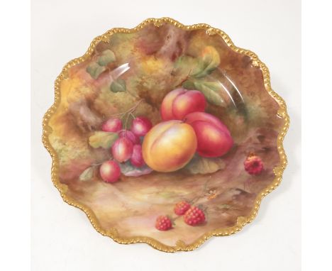 A Royal Worcester cabinet plate, hand painted with fruit to a mossy background by H H Price, with shaped gilt edge, dated 192