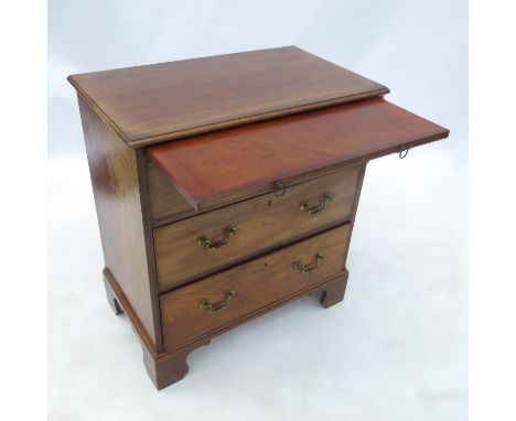 A late Georgian mahogany chest, with three graduated long drawers fitted below a brushing slide, raised on bracket feet, widt