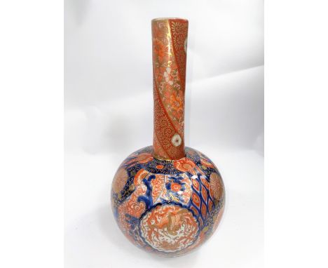 A Japanese Imarai bottle vase with detailed decoration of birds in panels with detailed gilt, red and orange, with three char