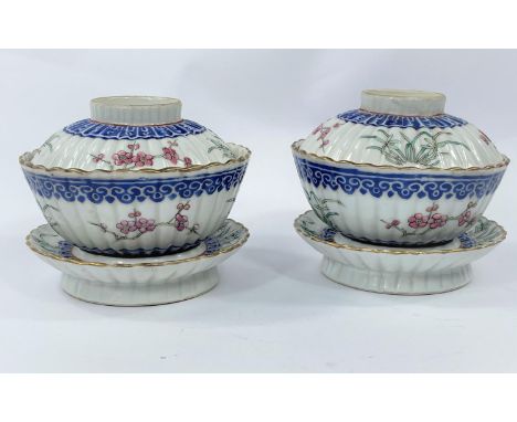 A pair of 19tth century Chinese lidded rice bowls with matching circular rest, of ribbed form with polychrome decoration, red