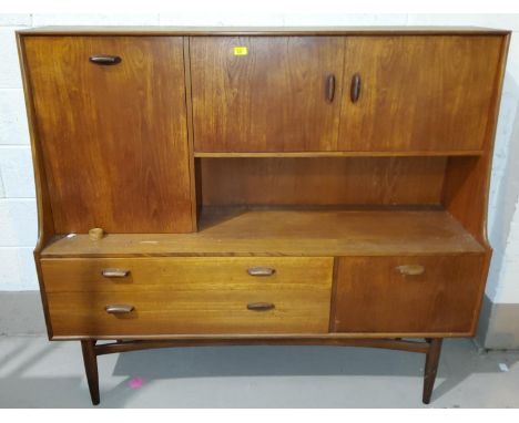 A 1960's G-Plan teak full height sideboard with 3 cupboards and open shelf over 2 doors and a single cupboard 