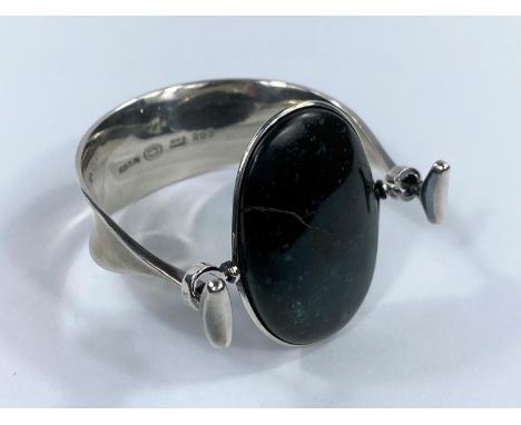 Georg Jensen: a silver bracelet/bangle designed by Vivianna Torun Bülow-Hübe, set oval polished cabochon moss agate (see imag