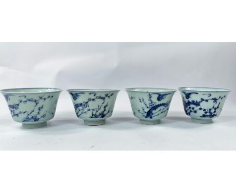 Four Chinese blue and white tea bowls with Prunus blossom decoration with birds, a character mark to the base and similar to 
