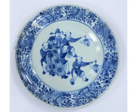 A Chinese blue and white porcelian plate with central panel of old sage being helped by four younger people, two with lantern