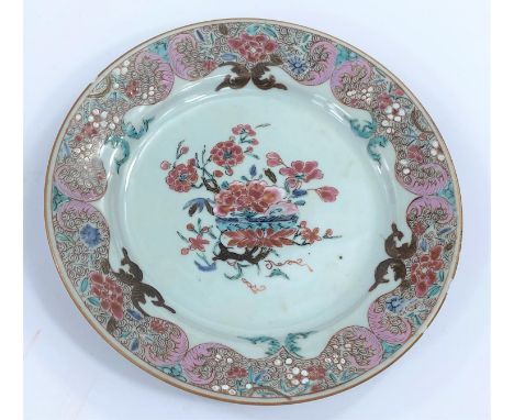 A 19th century Chinese famille rose plated decorated with flowers etc, d. 22.5cm.&nbsp;some rim chips, one small patch of wea