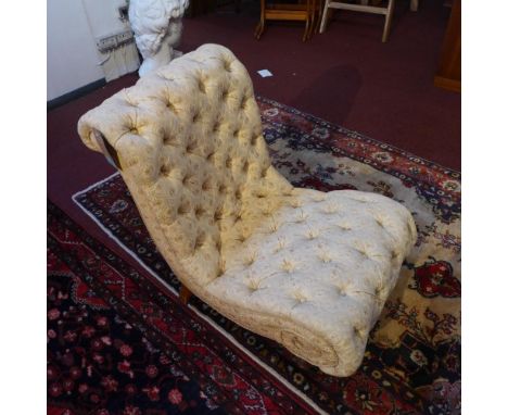 A Victorian mahogany slipper chair, with button back upholstery raised on turned legs and castors 
