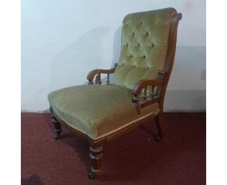 A Victorian mahogany chair, with button back velour upholstery, raised on turned legs and castors 