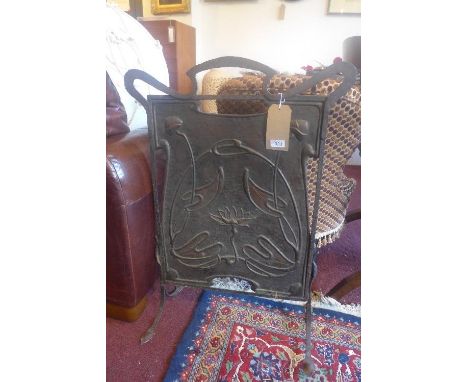 An Art Nouveau copper and cast iron fire screen, decorated with water lillies, H.84 W.60cm 