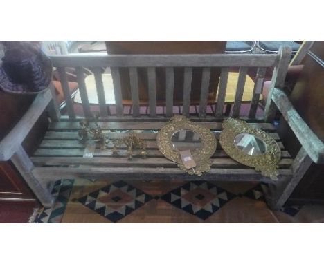 A weathered teak garden bench of slatted construction, H.86cm W.152cm 