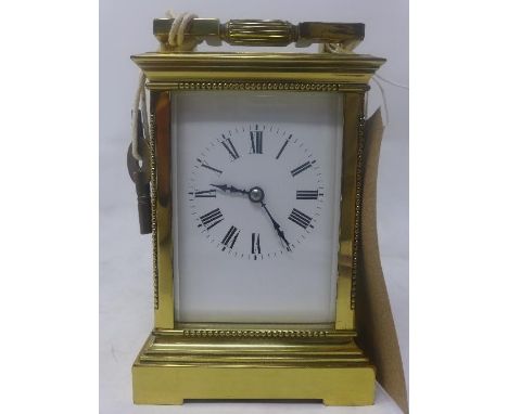 A polished brass carriage clock, white enamel dial with Roman numerals, chiming gong, H.17cm 