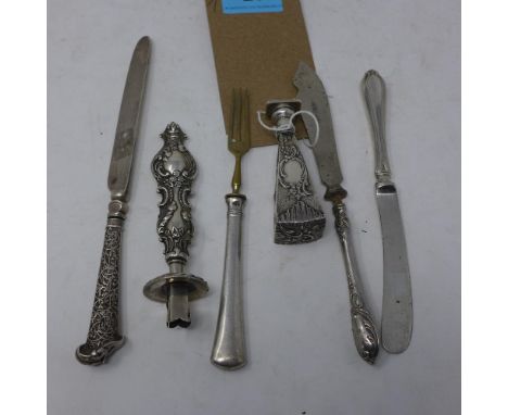 A collection of six silver items, to include a Continental silver stamp of tapered form, decorated with flowers, C-scrolls an