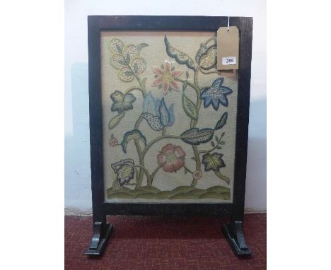 An Art Nouveau fire screen, with glazed stump work embroidered panel 