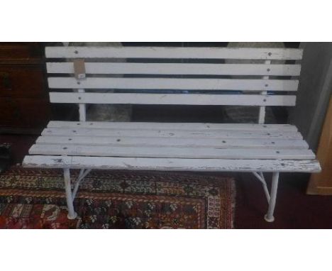 A garden bench with white painted slats on a tubular metal frame, H.75cm W.140cm 