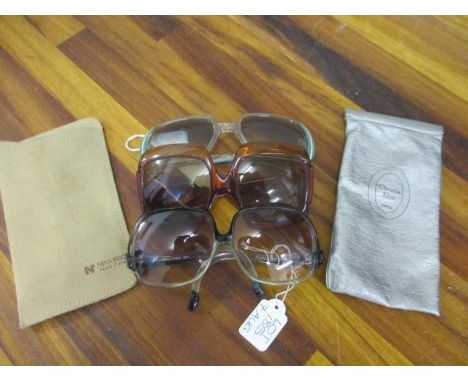 A pair of Retro Christian Dior brown oversized sun glasses together with a pair of Nina Ricci oversized sunglasses in a clear