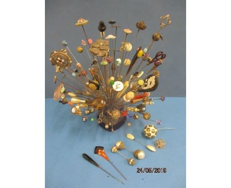 A large collection of early 20th century hat pins to include Arts &amp; Crafts enamelled pins, Art Deco and French pins, silv