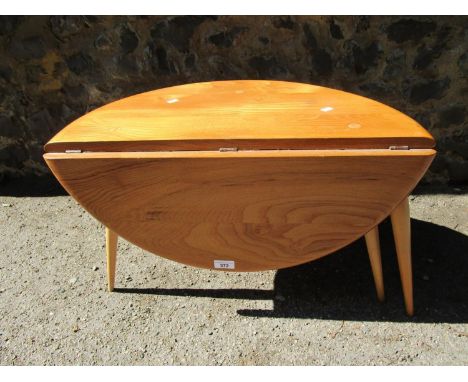 An Ercol small half moon drop flap coffee table in beech and walnut design 308, blue and gold Ercol paper label to the unders