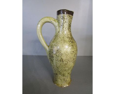 A Martin Bros stoneware jug by Robert Wallace Martin decorated with fine brown spots on a creamy yellow tinted glaze, incised