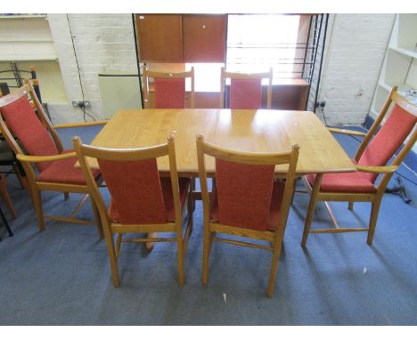 An Ercol light oak Windsor 1193 extending dining table with rising leaf, maker's label to underside 28 1/2" x 58" x 36", with