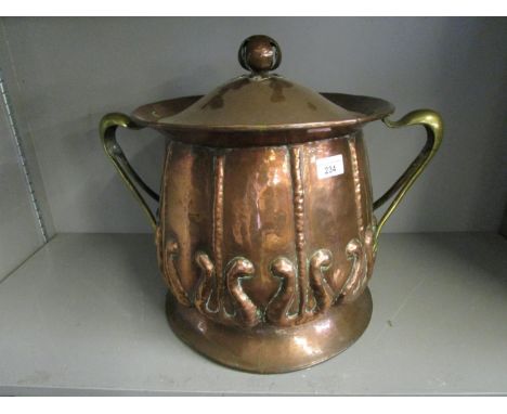 A Victorian hammered Arts &amp; Crafts copper and brass coal bin with tin liner, lid with open bud like finial, sinuous brass