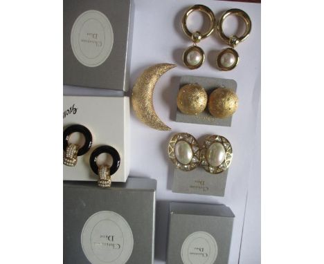 Four pairs of Christian Dior oversized clip on earrings, a Christian Dior gold-tone crescent moon shaped brooch decorated wit