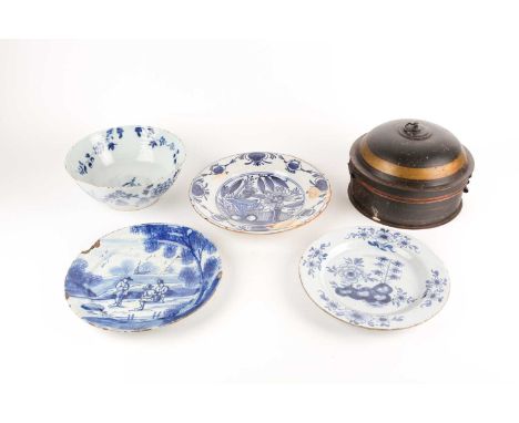 An 18th century delftware bowl and three plates, the bowl and a plate similarly decorated, painted with bamboo, rockwork and 