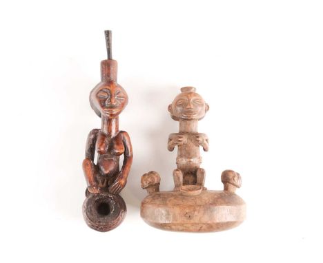 A Luba pipe, Democratic Republic of Congo, carved as a female figure with pronounced stomach above a spherical bowl with carv