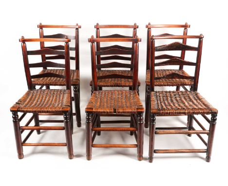 A set of six early 19th-century Macclesfield type ladder back dining chairs with distinctive cresting rails above woven rush 