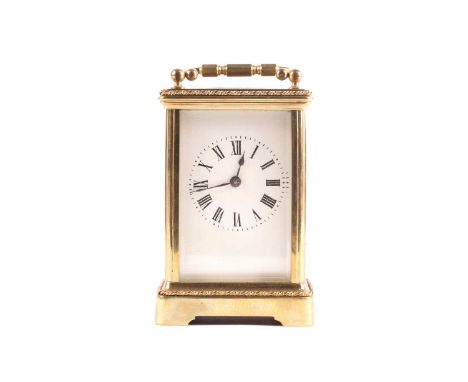 A late 19th-century French brass and four-glass carriage clock, the enamel dial bearing Roman numerals, 15.5 cm (handle up).C