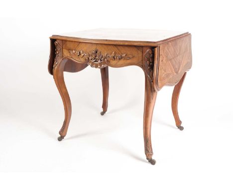 A Louis XV style two flap low rosewood table of serpentine form. Fitted a single frieze drawer carved with scrolls and fruit.