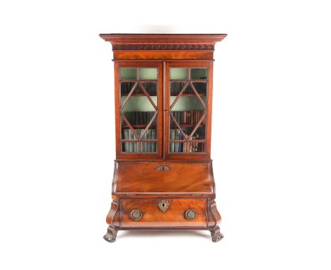 A Chippendale style miniature mahogany bombe bureau bookcase. The upper section with arcaded frieze over a pair of "Diamond" 