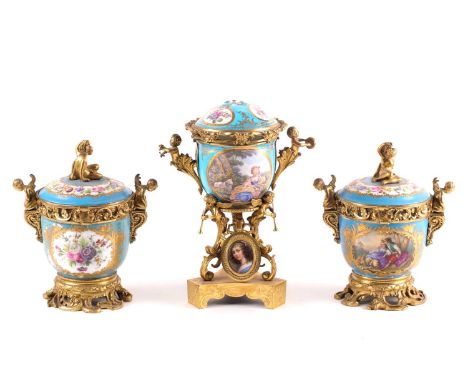 A 19th century ormolu-mounted Sevres bleu celeste urn and cover. Painted with bucolic landscapes and cut blooms. With musical