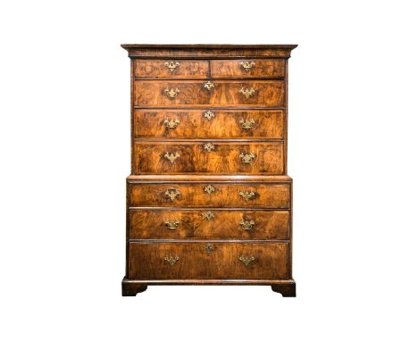 A George I figured walnut chest on chest fitted with eight "book matched" and "herringbone banded drawers". and cross-grain m