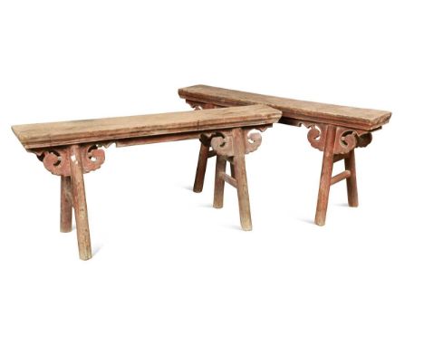 A pair of Chinese provincial part red painted benches, late Qing Dynasty,  the plain wood tops on pairs of tapering legs with