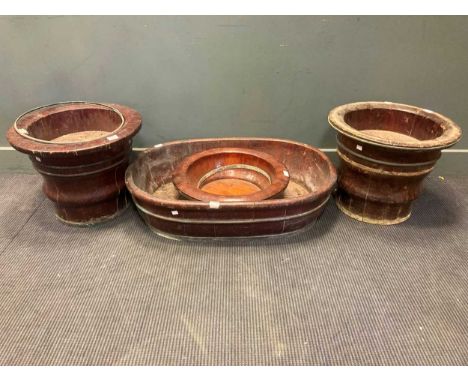 A pair of brass banded wooden planters and large oval planter and one other round planter (4)