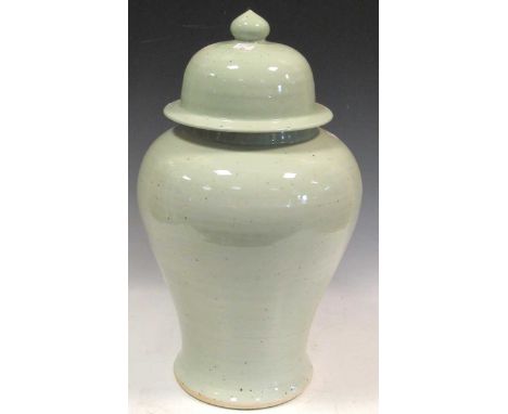 A Chinese light green glazed ceramic lidded urn, 50cm high