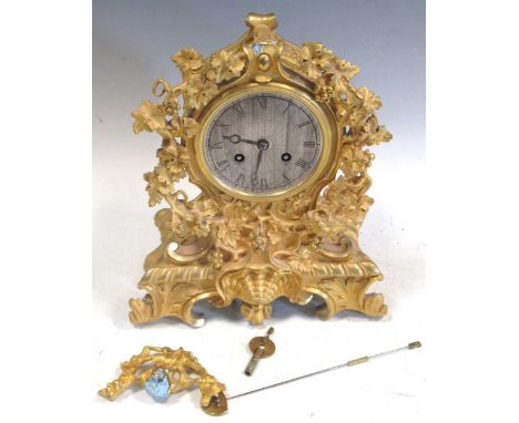 A 19th century ormolu case mantel clock in Rococo style, with silk suspension movement