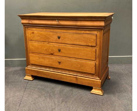 A Continental Biedermeier style fruitwood commode, comprising of a frieze drawer over three long drawers and an apron drawer 