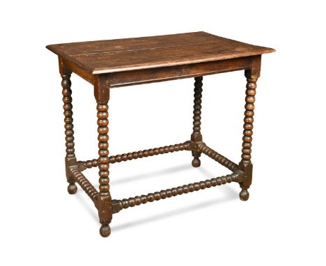 An oak bobbin turned centre table, early 18th century, the two plank moulded top raised on bobbin turned legs and stretchers 